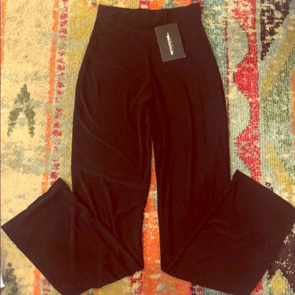 Tight black wide leg trousers